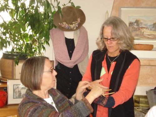 PJ is knitting gloves for Afghans and Susanne is her model!